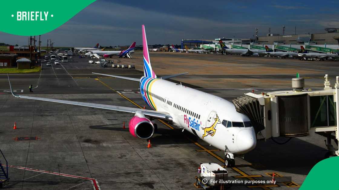 Kempton Park, Johannesburg, Gauteng, South Africa: a FlySafair Boeing 737-8K2, MSN 28373, passenger aircraft, bearing the registration ZS-ZWO, docked at a passenger boarding bridge at O.R. Tambo International Airport in Johannesburg, South Africa