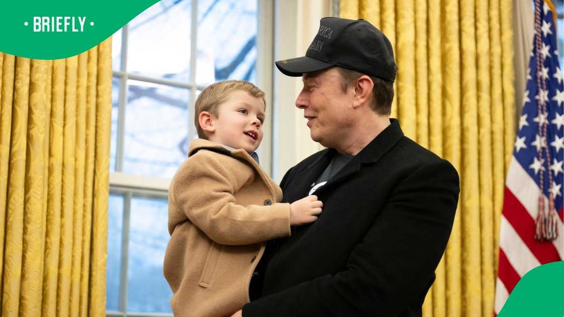 Elon Musk carries his son X Æ A-Xii in the Oval Office of the White House in Washington, DC.