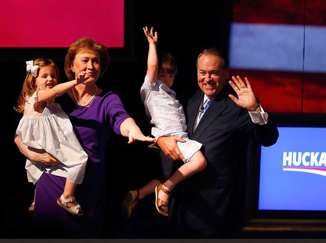 Mike Huckabee and his wife, Janet, hold their grandchildren Scarlet Sanders (L), 3, and Chandler Huckabee, 3