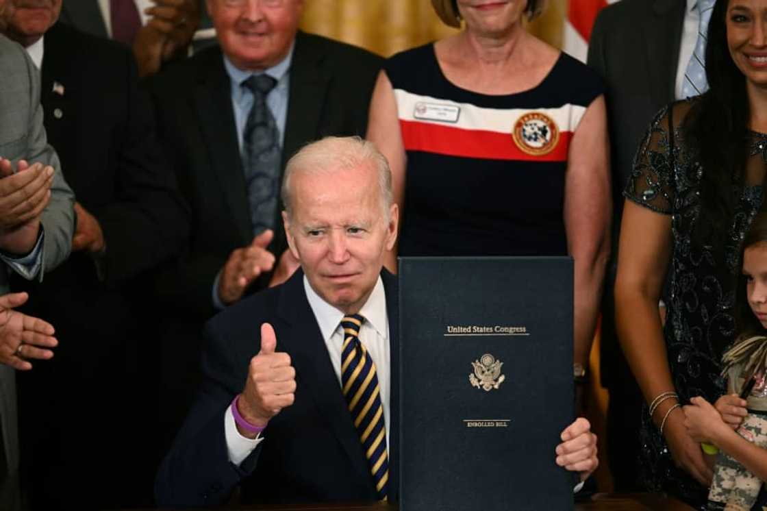 US President Joe Biden gives a thumbs up during a signing ceremony for the PACT Act for veterans exposed to toxic burn pits