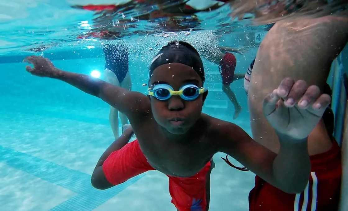 A Black youth takes part in a class sponsored by Swim Up, which promotes swimming among African Americans A Black youth takes part in a class sponsored by Swim Up, which promotes swimming among African Americans