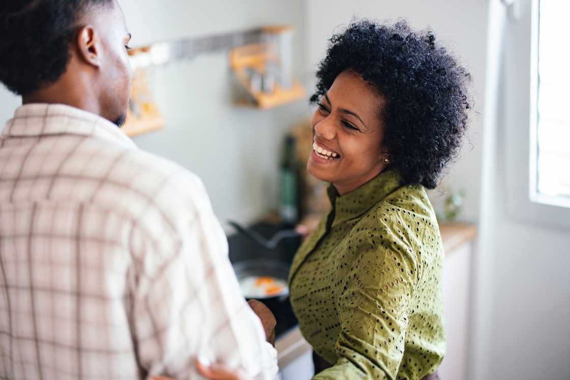 A smiling mom and son shares breakfast in the kitchen