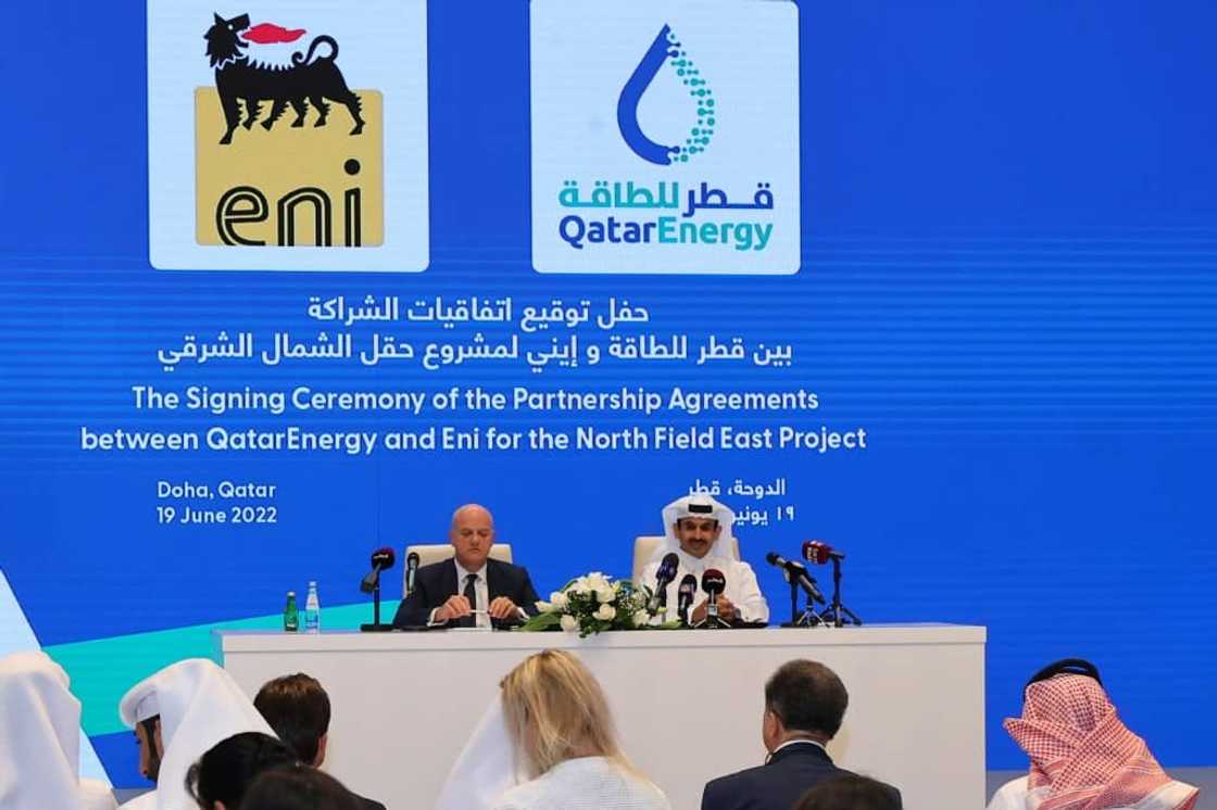 Qatar's Energy Minister and president and CEO of QatarEnergy Saad Sherida al-Kaabi (R) and Claudio Descalzi, CEO of Italian multinational oil and gas company ENI, attend the signing ceremony for their joint venture