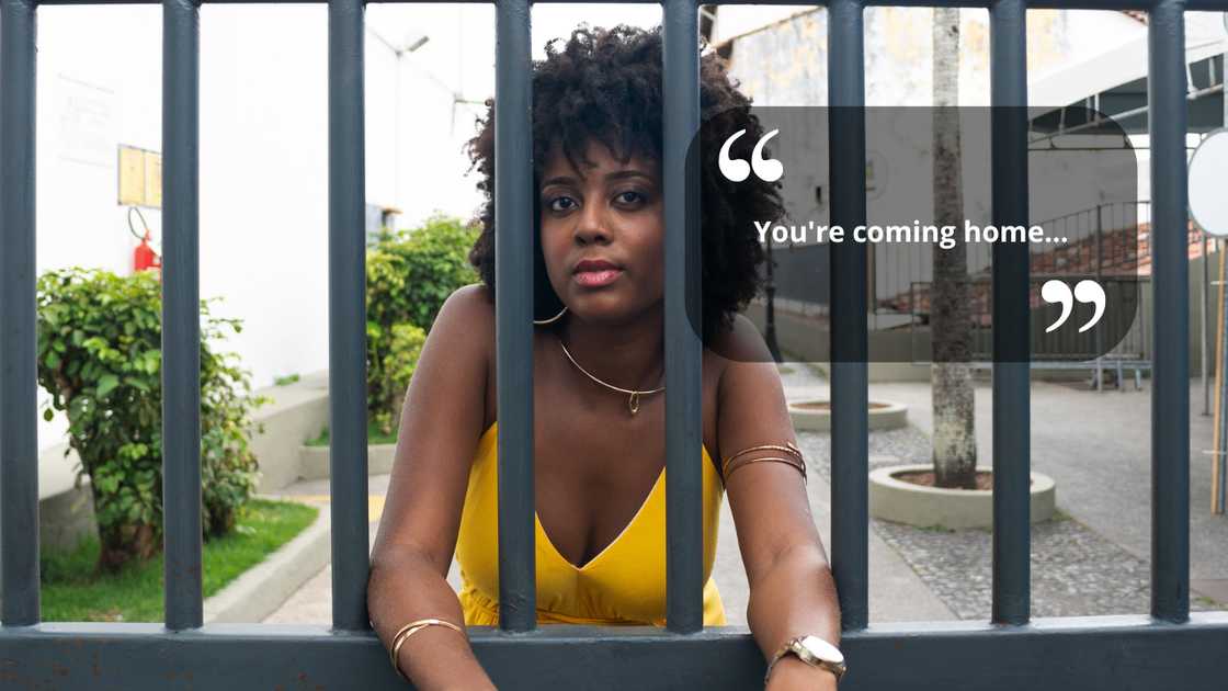 A woman standing outside an iron gate A woman standing outside an iron gate