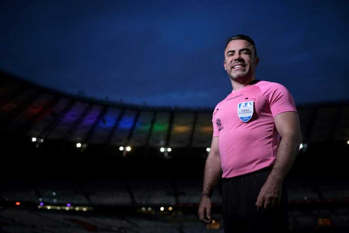 Brazilian premier league official Igor Benevenuto, pictured at the Mineirao stadium illuminated with the colors of the rainbow flag in Belo Horizonte, is one of a few trailblazing referees to publicly identify as gay