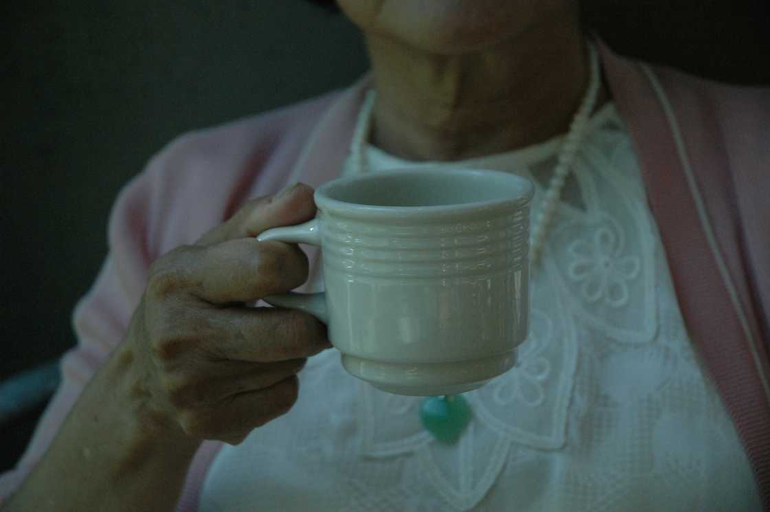 A woman holding a cup of tea
