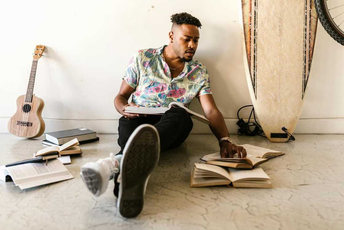 A student sitting on the floor studying A student sitting on the floor studying