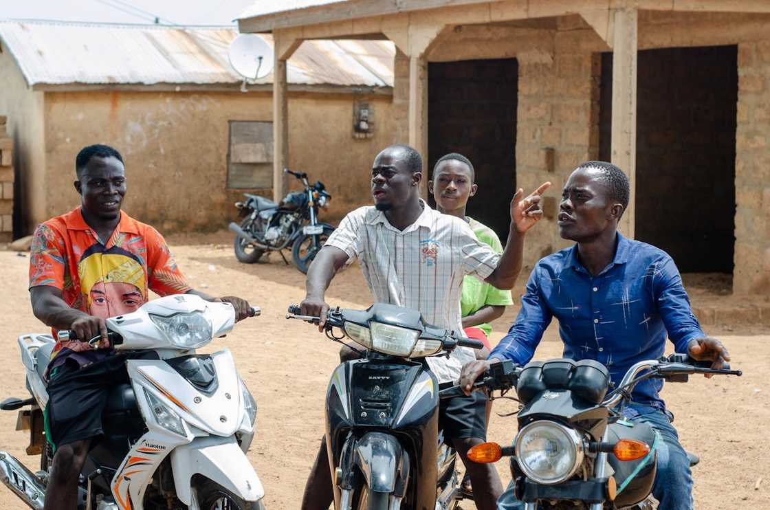 Group of young men sitting on motorbikes. Group of young men sitting on motorbikes.