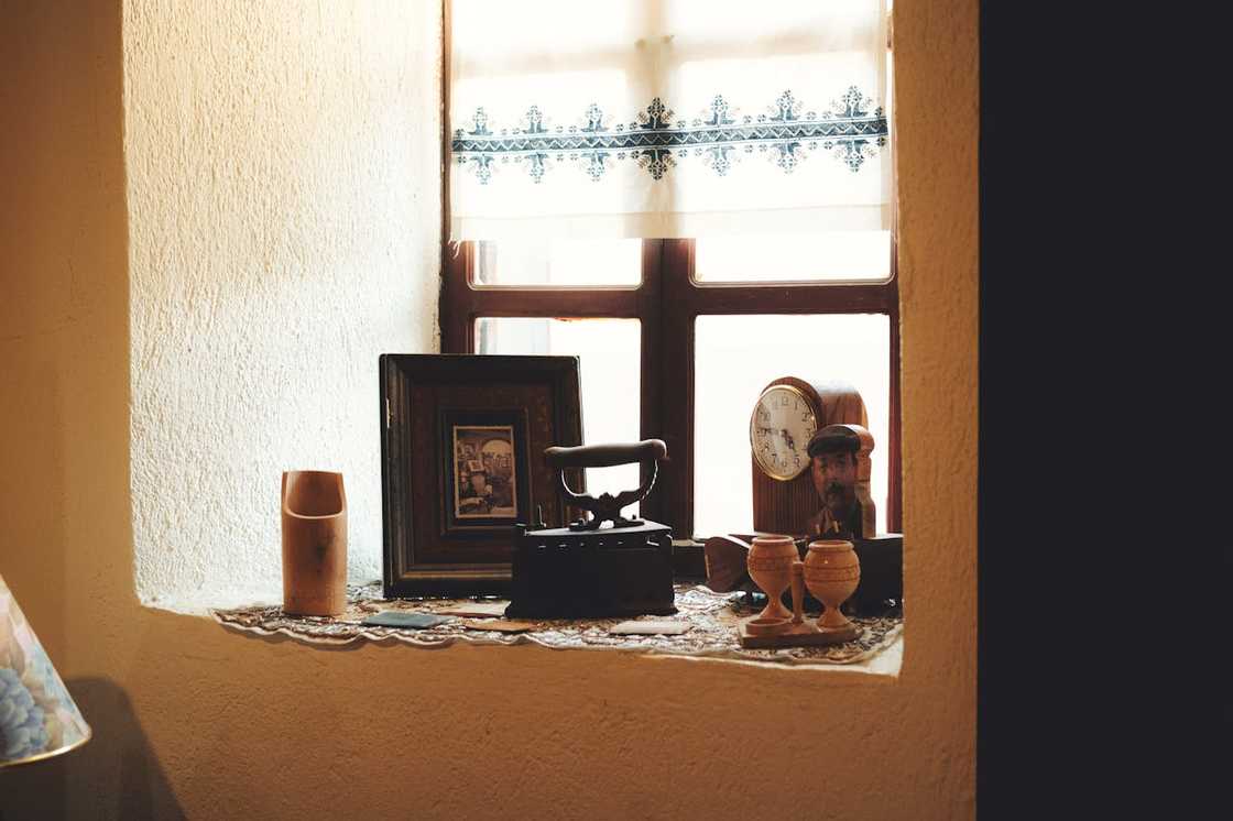 Old household items displayed on a window sill. Old household items displayed on a window sill.