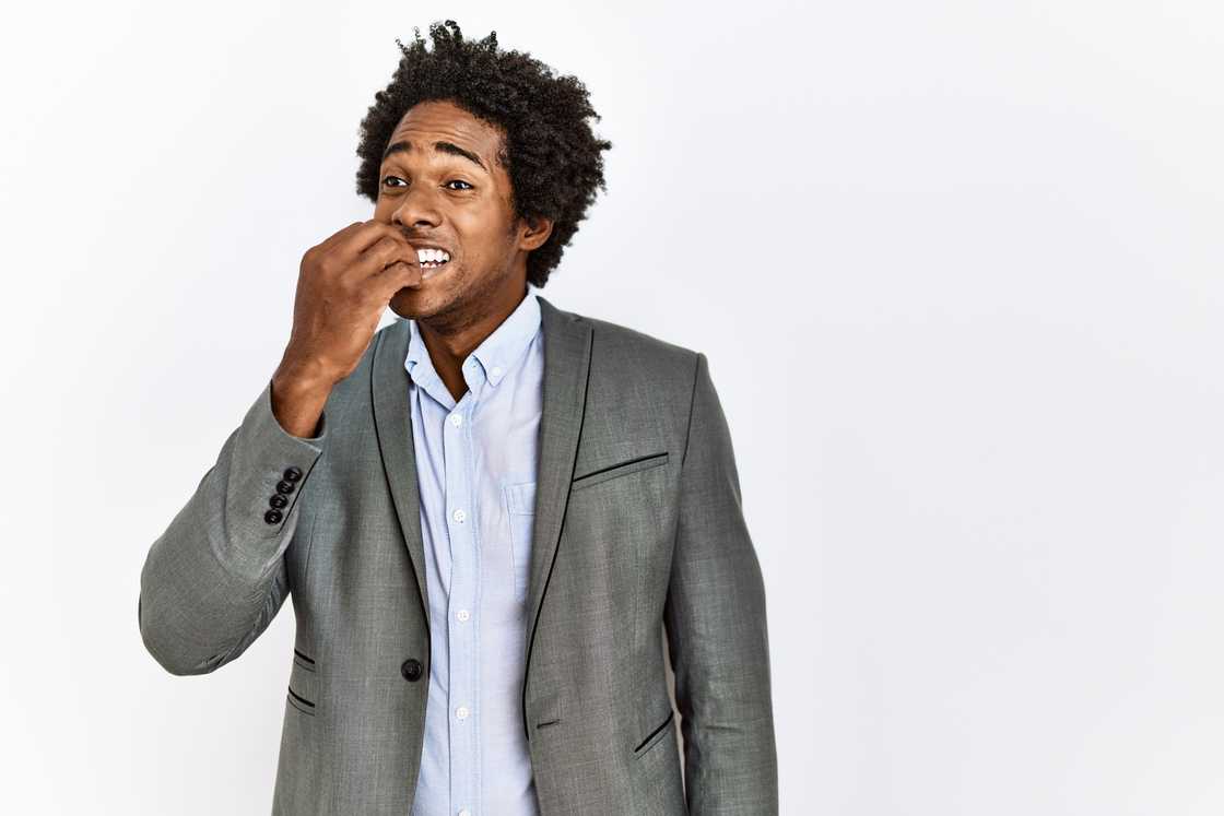 A nervous man biting his nails A nervous man biting his nails