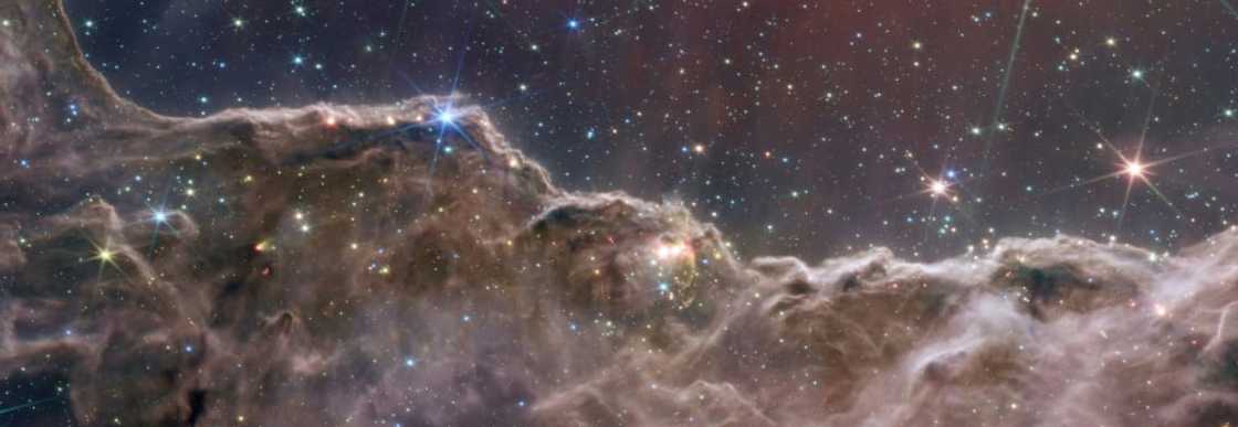 Perhaps the most beautiful image is that of the "Cosmic Cliffs" from the Carinal Nebula, a stellar nusery Perhaps the most beautiful image is that of the "Cosmic Cliffs" from the Carinal Nebula, a stellar nusery