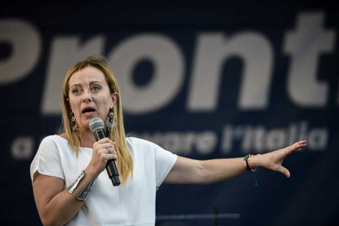 Brothers of Italy leader Giorgia Meloni addresses supporters during a rally, her election slogan "Pronti", or "Ready", behind her Brothers of Italy leader Giorgia Meloni addresses supporters during a rally, her election slogan "Pronti", or "Ready", behind her