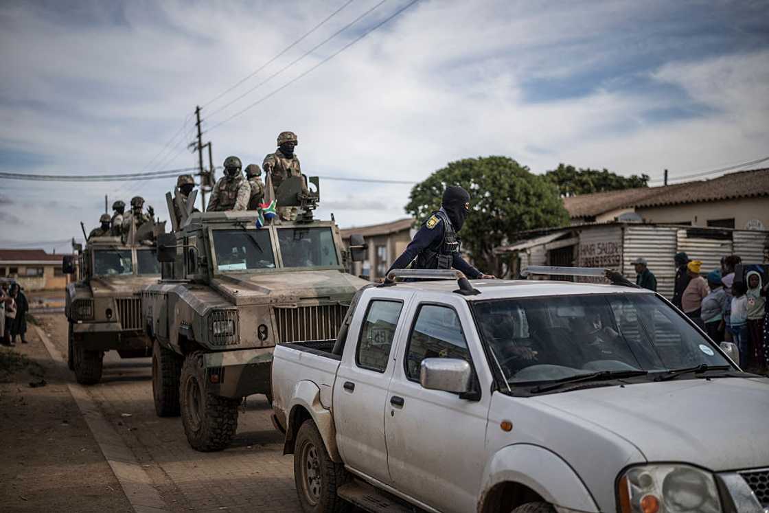 South African Police Service officers lead a convoy of South Africa National Defence Forces (SANDF) during a patrol in the Pellsrus township in Jeffreys Bay, on July 18, 2026 South African Police Service officers lead a convoy of South Africa National Defence Forces (SANDF) during a patrol in the Pellsrus township in Jeffreys Bay, on July 18, 2026