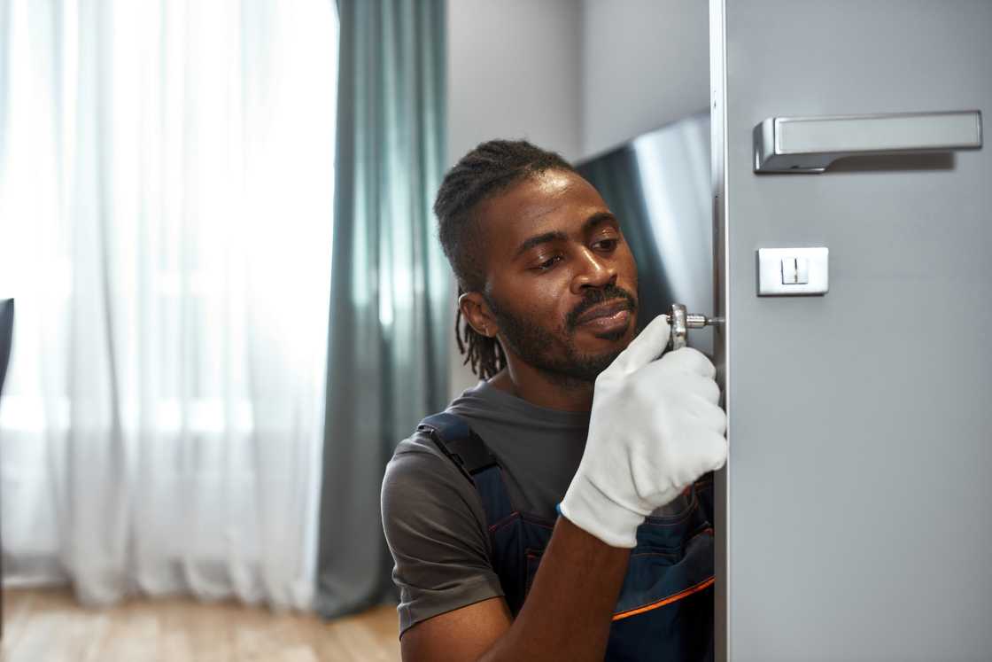 A locksmith fixing the door