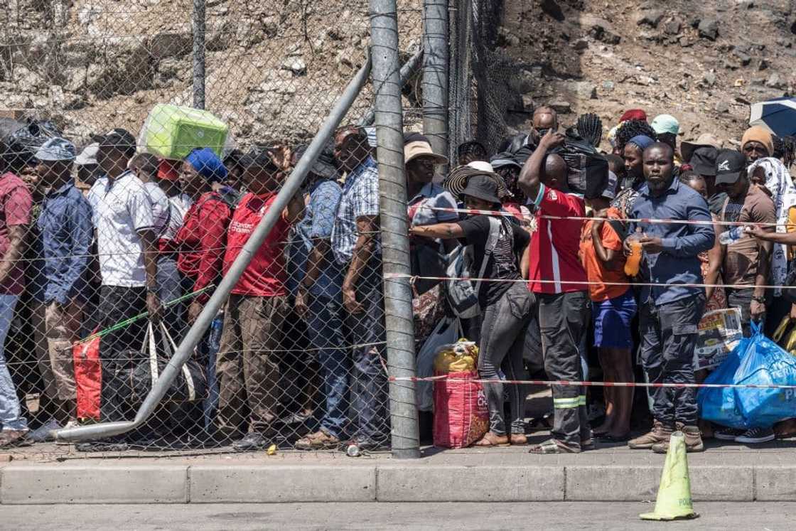 A queue of passengers returning to Zimbabwe is seen at the Beitbridge border crossing in South Africa on October 5, 2023