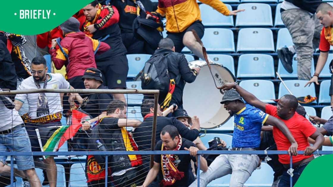 Mamelodi Sundowns fans and ES Tunis supporters clash at the Loftus Versfeld Stadium. Mamelodi Sundowns fans and ES Tunis supporters clash at the Loftus Versfeld Stadium.