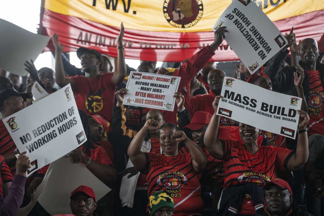South African holding up signs calling for worker's rights on Workers' Day South African holding up signs calling for worker's rights on Workers' Day