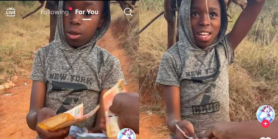 BI Phakathi gives a little boy a lot of money. BI Phakathi gives a little boy a lot of money.