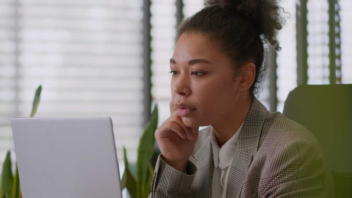 A worried woman watching a CCTV footage