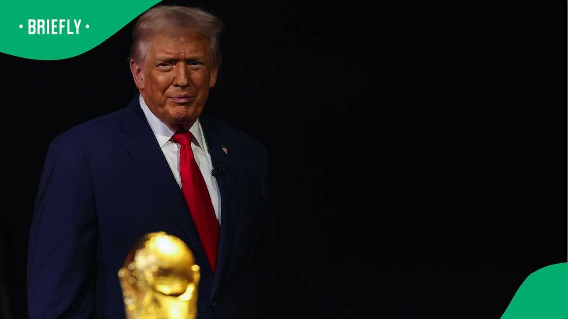 US President Donald Trump looking at FIFA World Cup trophy US President Donald Trump looking at FIFA World Cup trophy