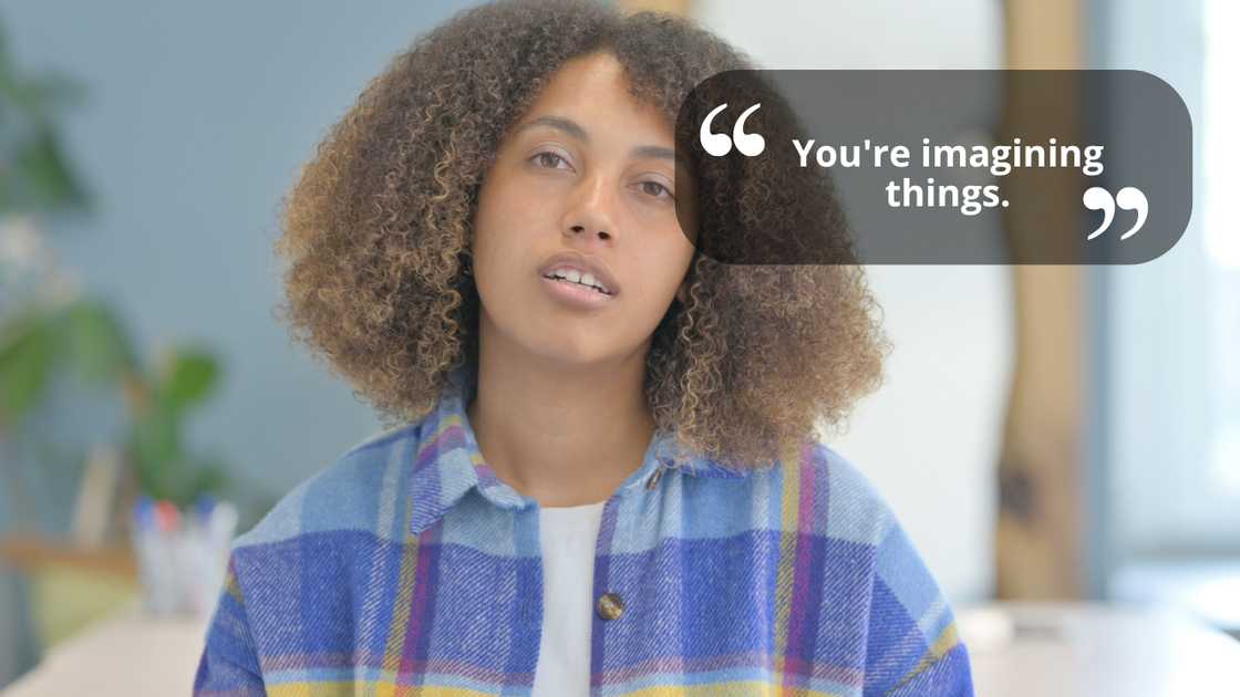 A young woman with curly hair talking while looking at the camera