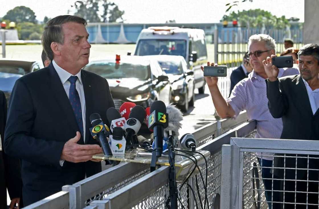 Bolsonaro speaks to journalists outside the presidential residence in 2020 -- a custom that has since disappeared Bolsonaro speaks to journalists outside the presidential residence in 2020 -- a custom that has since disappeared
