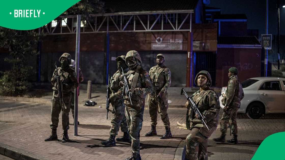 Soldiers with the South African National Defence Forces (SANDF) patrol the scene of looting in the Umlazi area of Durban, on June 30, 2026 Soldiers with the South African National Defence Forces (SANDF) patrol the scene of looting in the Umlazi area of Durban, on June 30, 2026