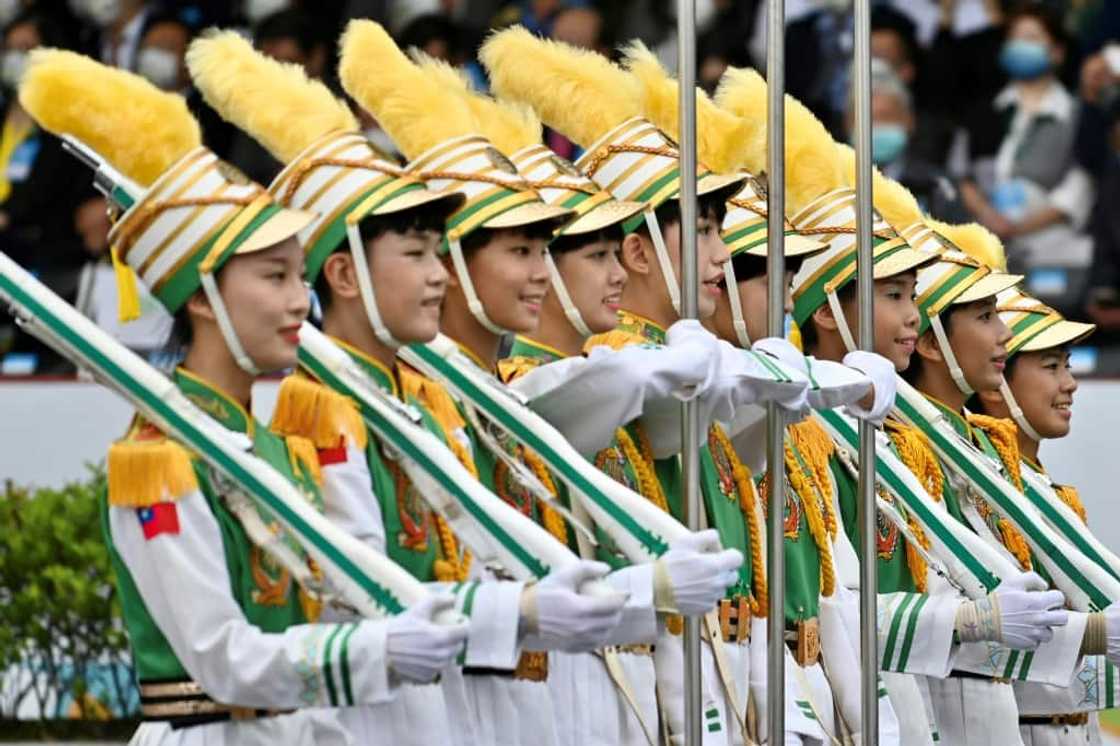 Students perform during celebrations to mark the island's National Day in front of the Presidential Office in Taipei on October 10, 2022. Students perform during celebrations to mark the island's National Day in front of the Presidential Office in Taipei on October 10, 2022.