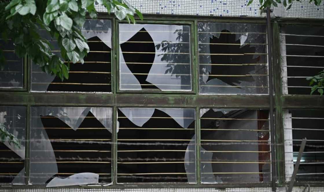 The broken windows of a nearby building The broken windows of a nearby building