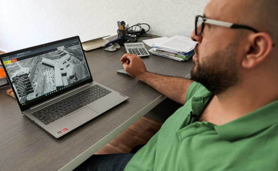 Diab Serriya, of the Association of Detainees and the Missing in Sednaya Prison, views a computer screen showing an image of the prison