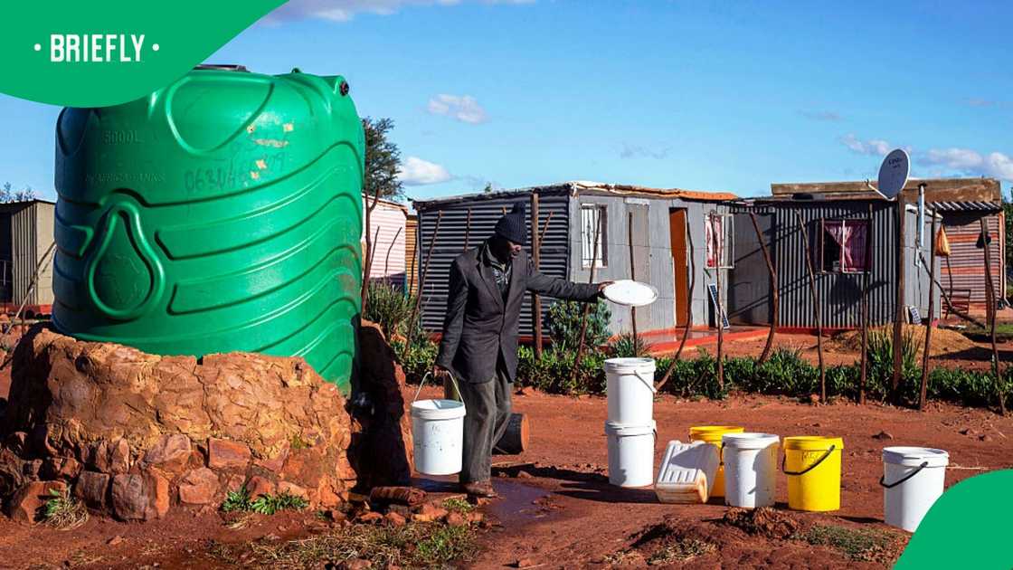 A man collects water at a communal water tank in an informal settlement on May 6, 2026 in Mountain City south of Johannesburg, South Africa. Thousands of households stay in this settlement, living on illegally occupied land since 2000. A man collects water at a communal water tank in an informal settlement on May 6, 2026 in Mountain City south of Johannesburg, South Africa. Thousands of households stay in this settlement, living on illegally occupied land since 2000.