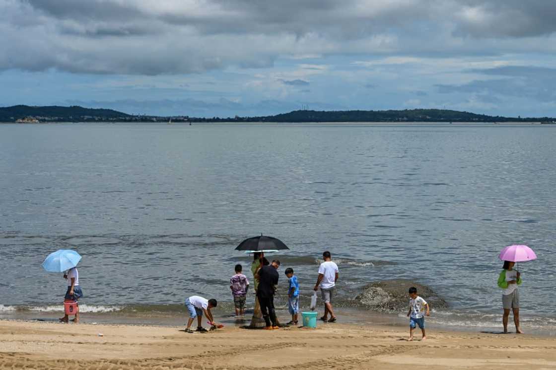 People gather at the beach in Xiamen, across from Taiwan's Kinmen Island People gather at the beach in Xiamen, across from Taiwan's Kinmen Island
