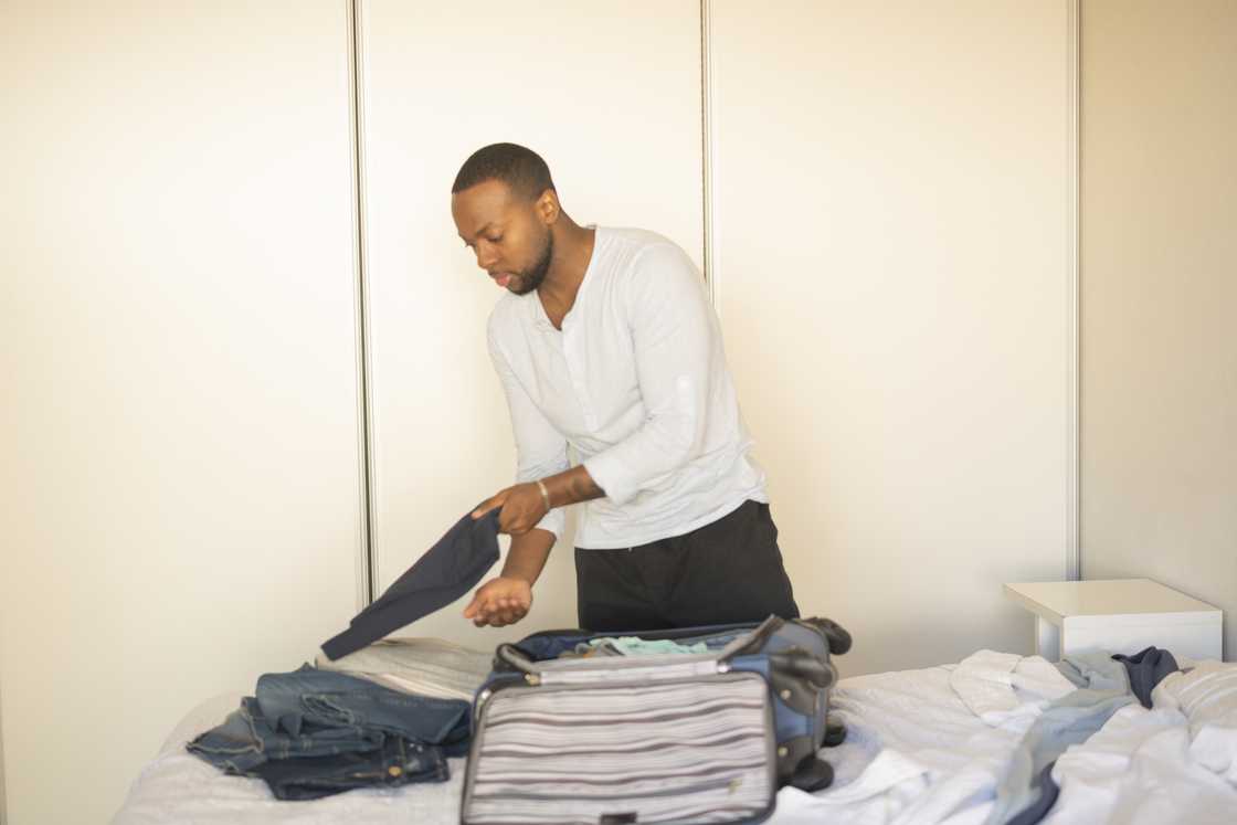 A man packing his suitcase A man packing his suitcase