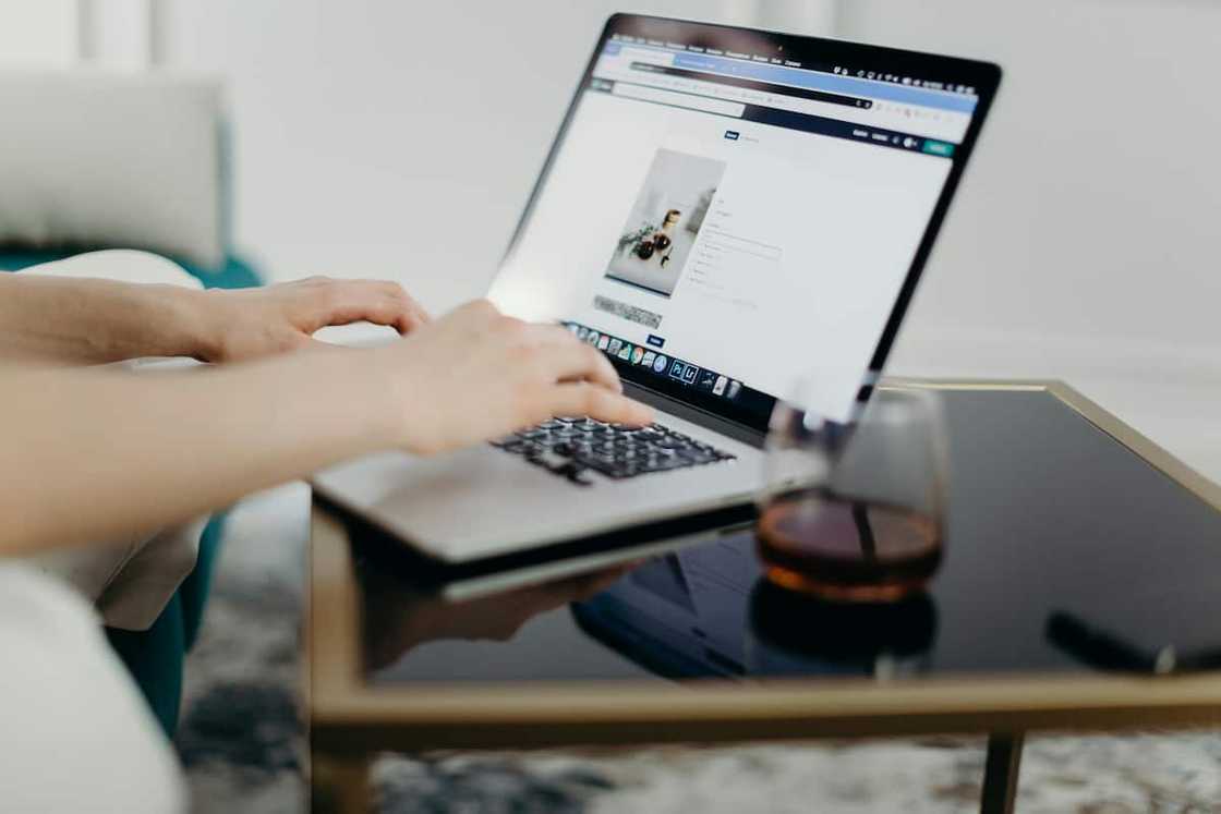 A woman typing on the laptop