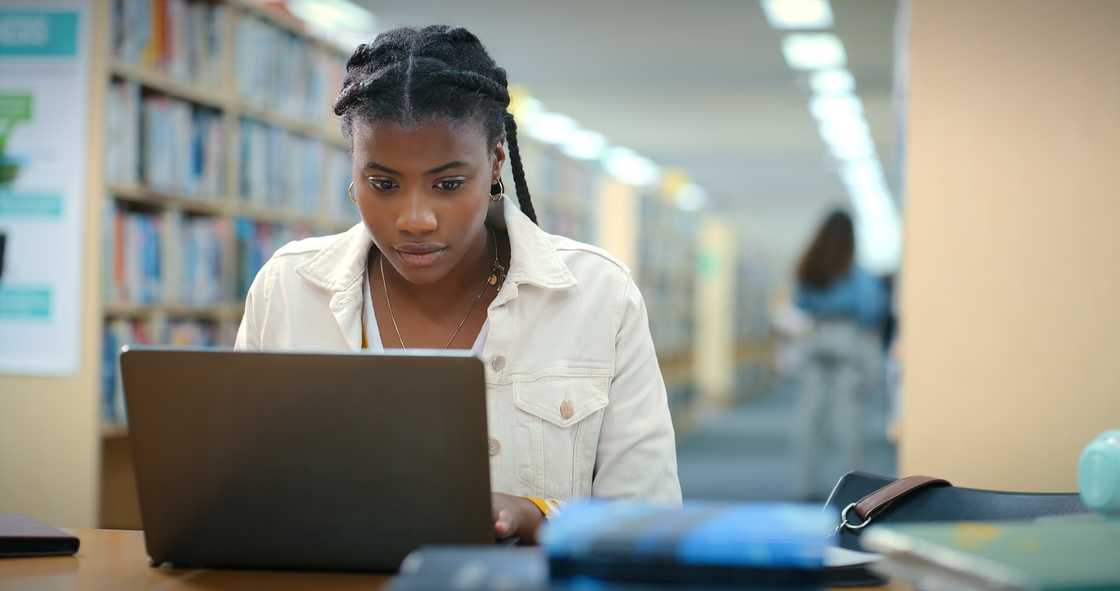 A student and laptop in library for education A student and laptop in library for education