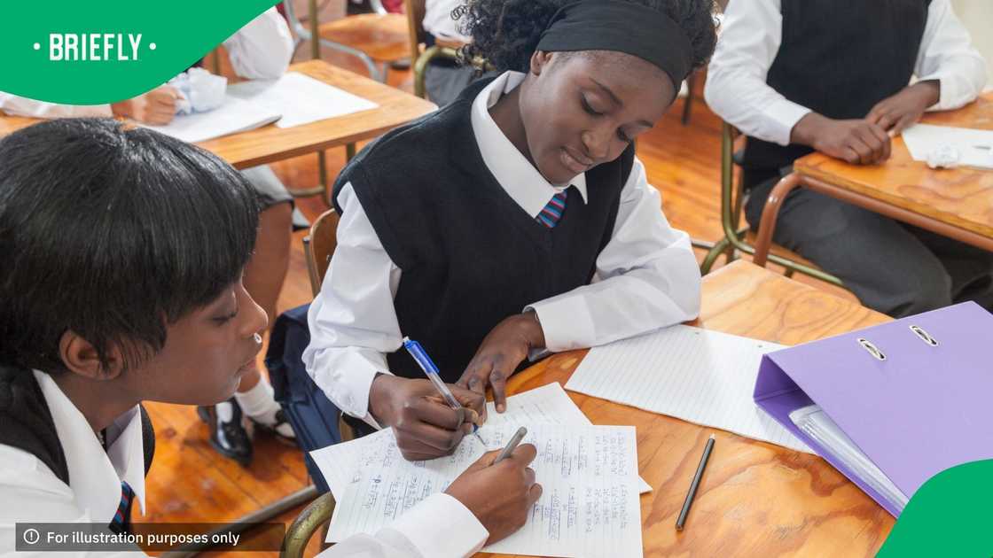 High school learners doing a classroom exercise High school learners doing a classroom exercise