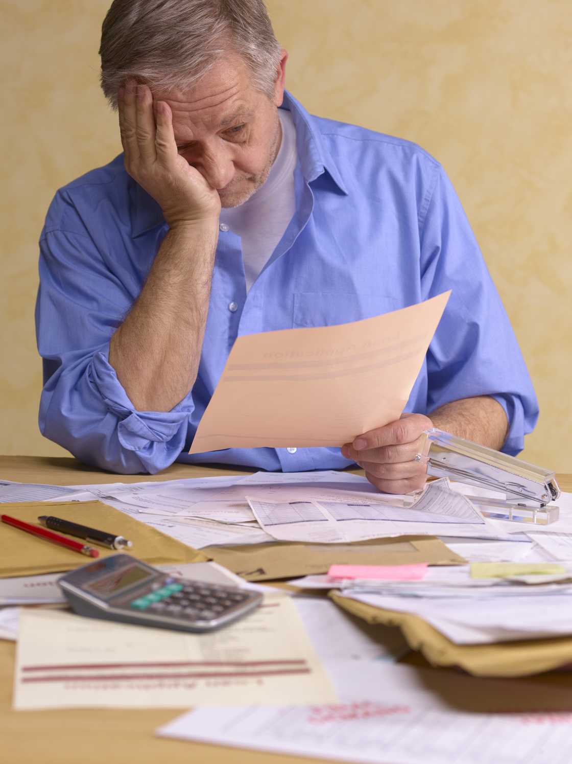 A stock image of senior man doing his tax return