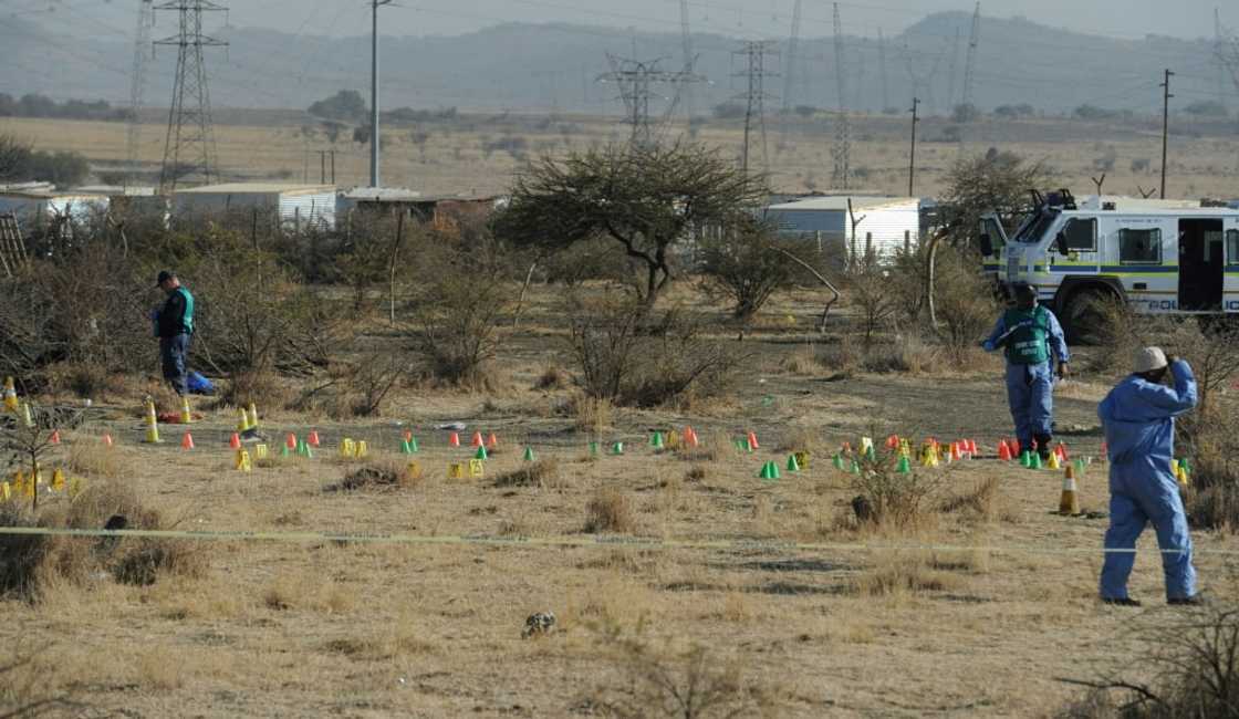 Aftermath: Police forensic experts at work the day after the massacre. A decade later, no-one has been charged over the deaths Aftermath: Police forensic experts at work the day after the massacre. A decade later, no-one has been charged over the deaths