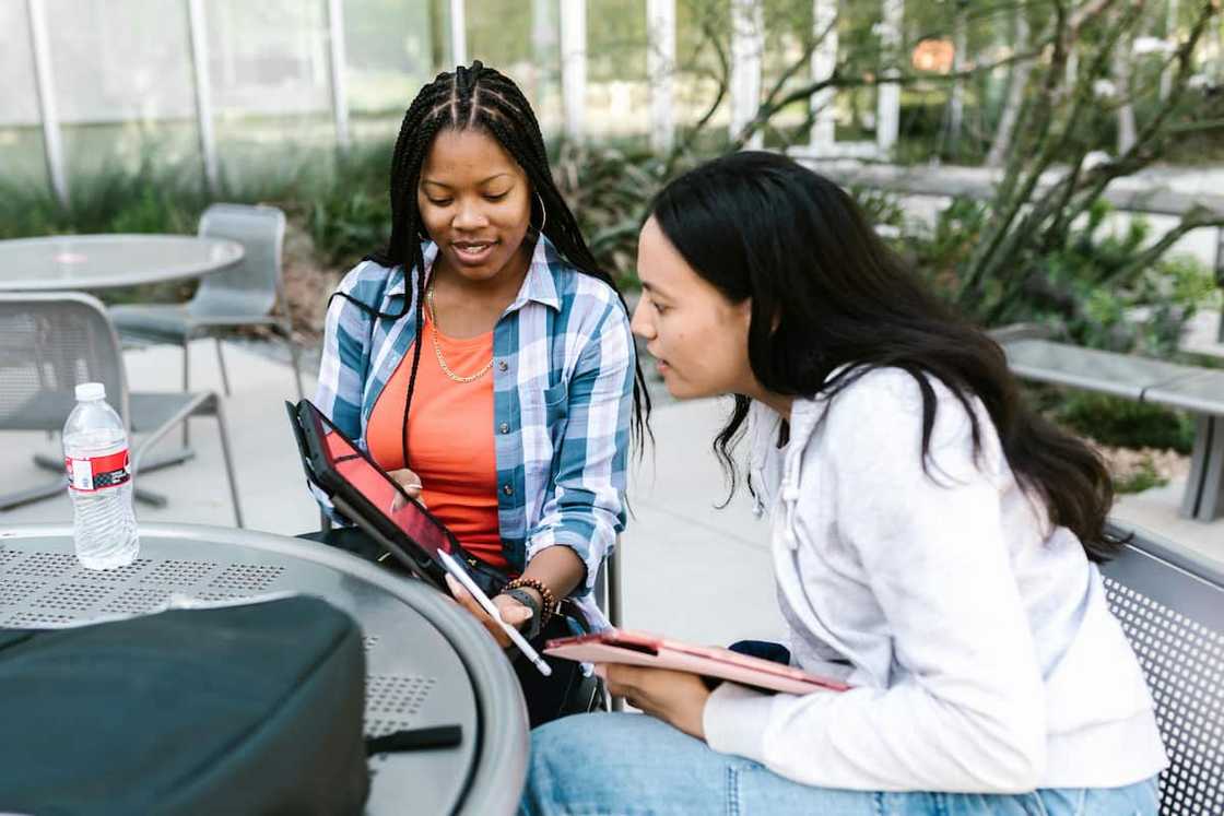 Two female students looking at a tablet