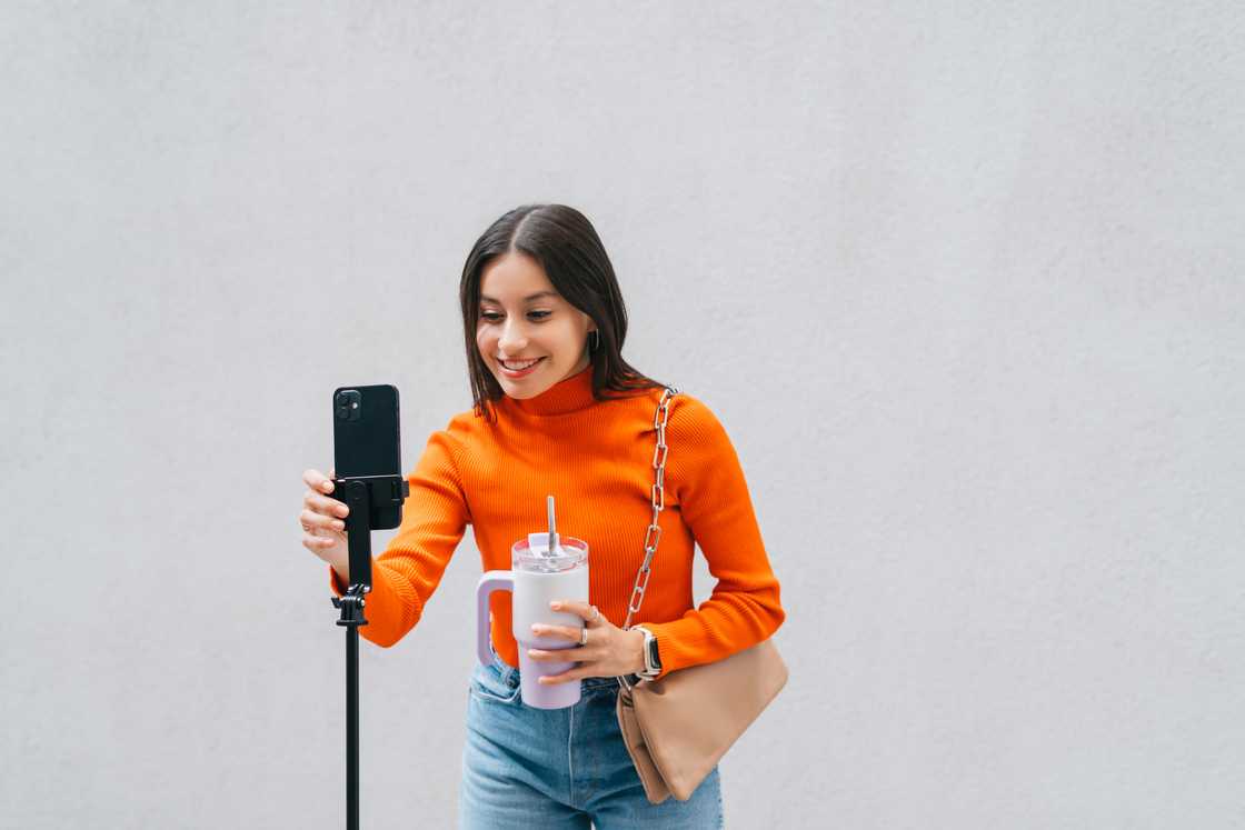 A woman recorded a video on her smartphone outdoors
