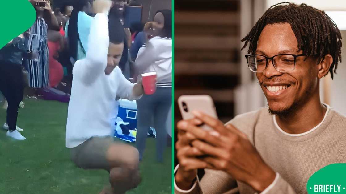 The man on the right was smiling warmly while looking at his phone indoors