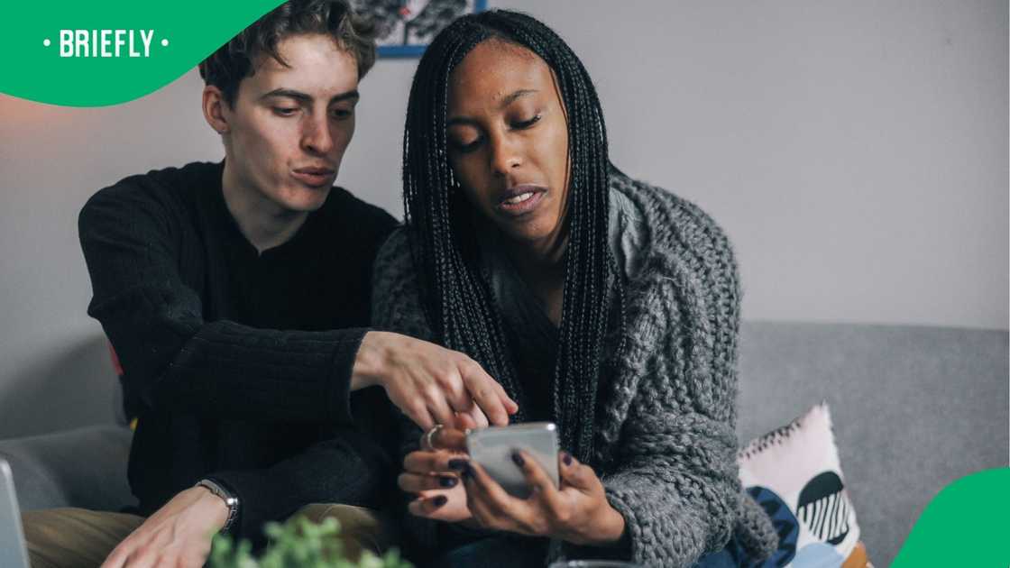 Young couple looking at something on a phone