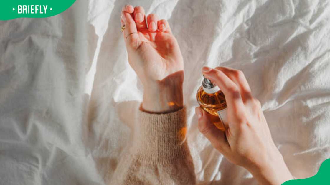 A woman spraying cologne