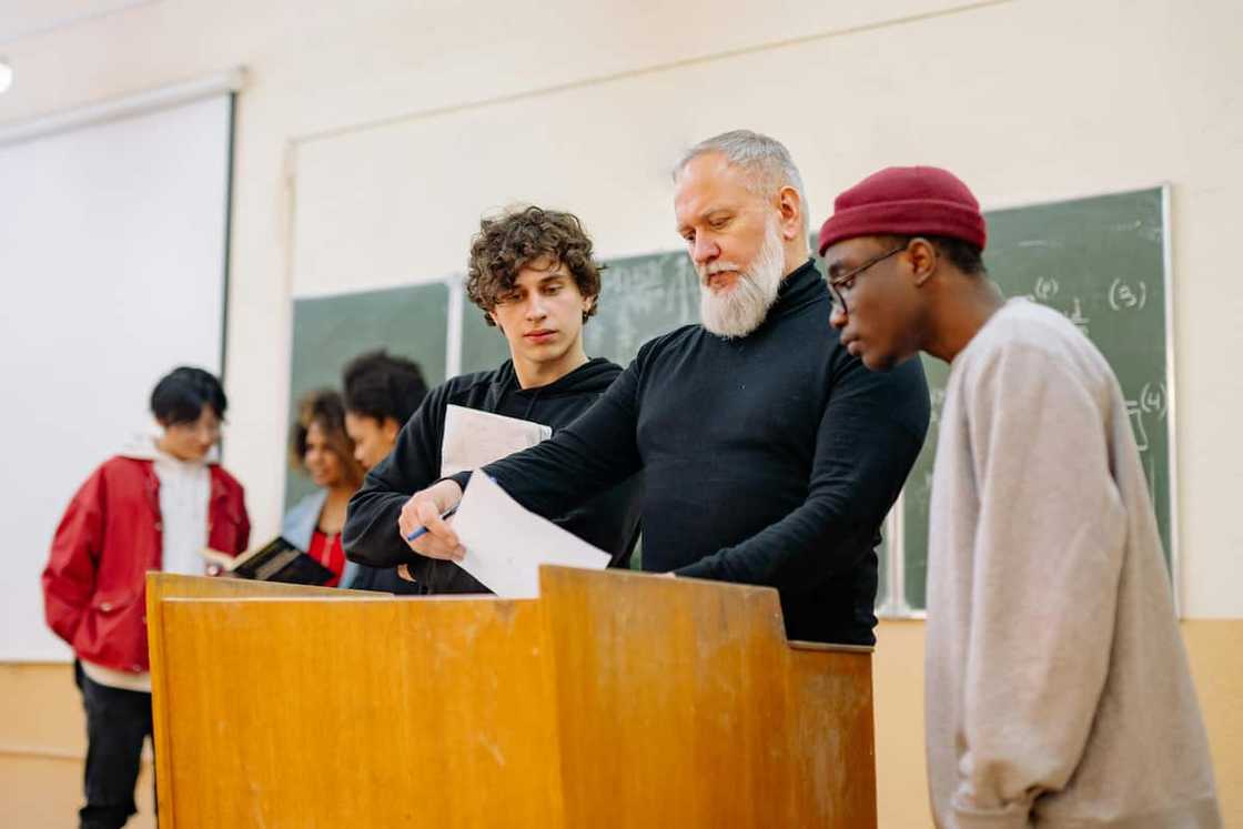 students standing next to their teacher