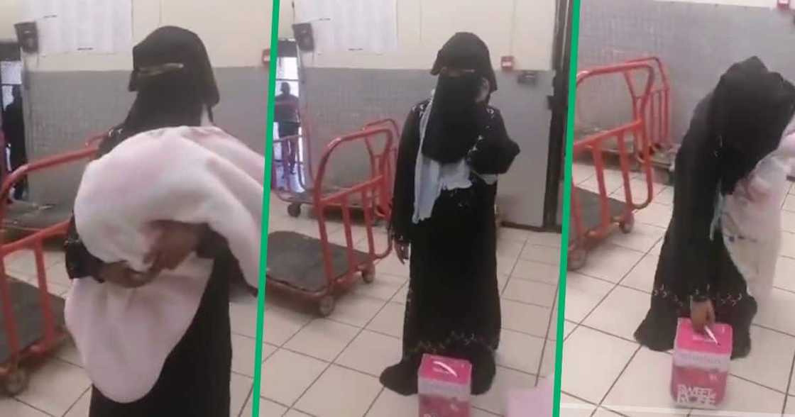 Woman dressed in hijab stealing wine in a shop