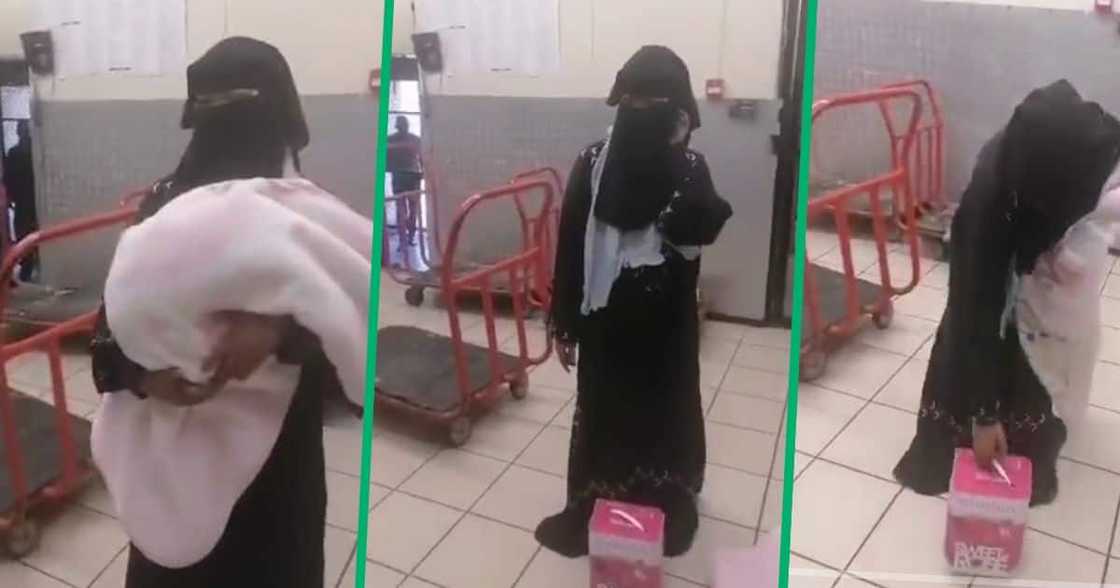 Woman dressed in hijab stealing wine in a shop Woman dressed in hijab stealing wine in a shop