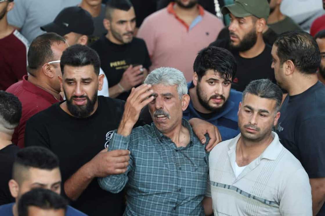 Mourners outside a hospital in Nablus on Sunday morning Mourners outside a hospital in Nablus on Sunday morning