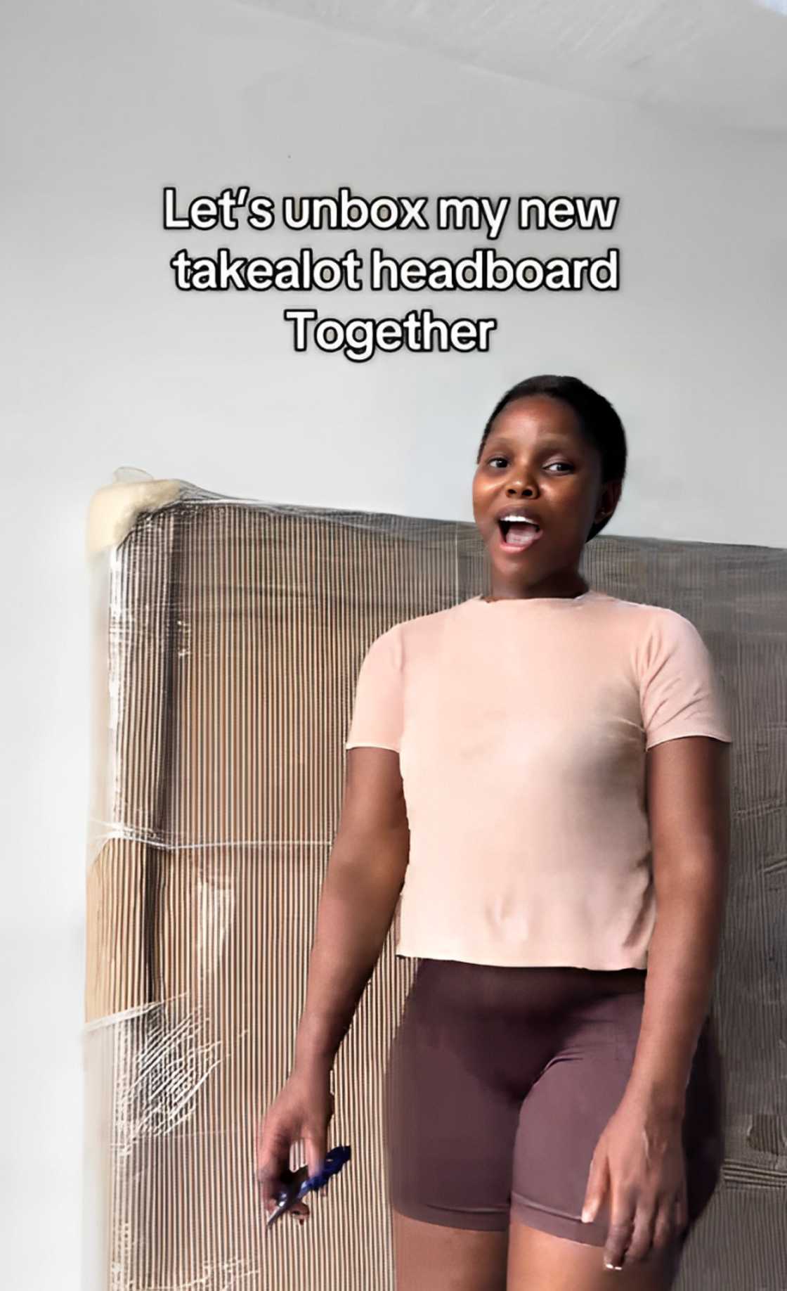 A woman unboxed the new headboard she got from Takealot