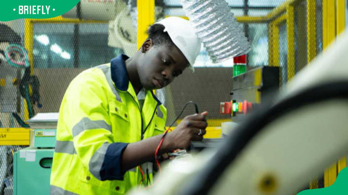 An electrical technician working with a digital multimeter An electrical technician working with a digital multimeter