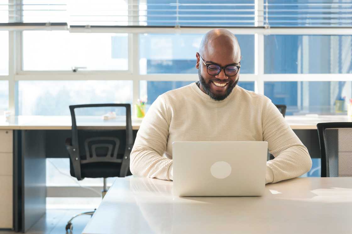 a happy man working on coding project